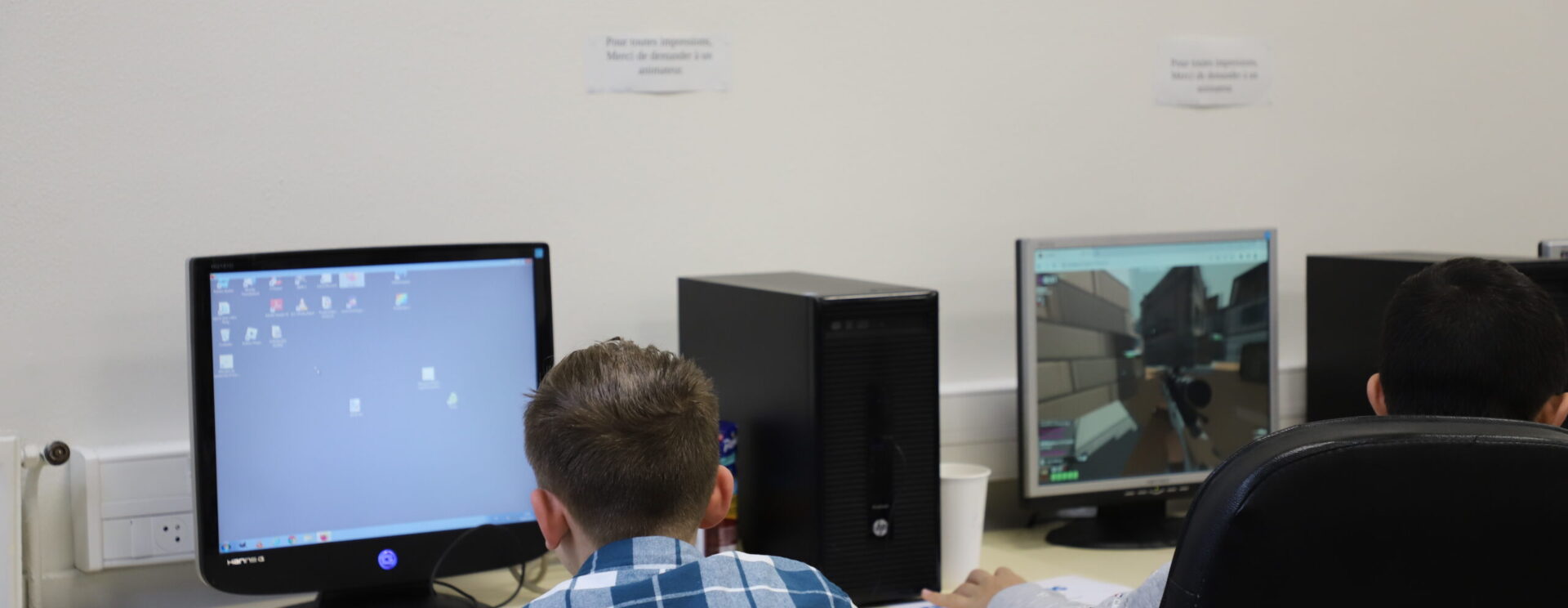 Enfant réalisant des recherches sur un ordinateur mis à disposition par la ville