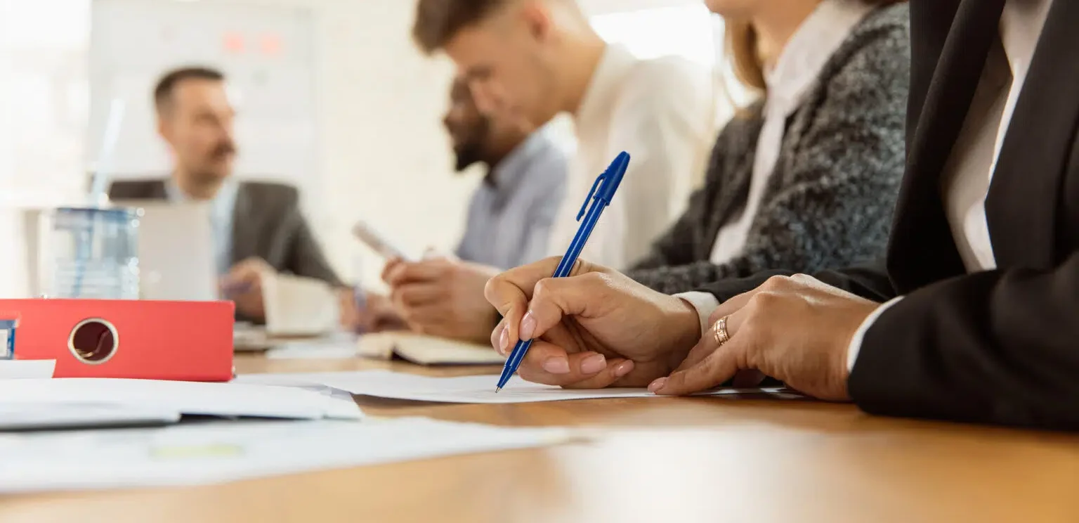 Image représentant des individus réunis autour d'une table et échangeant sur des dossiers